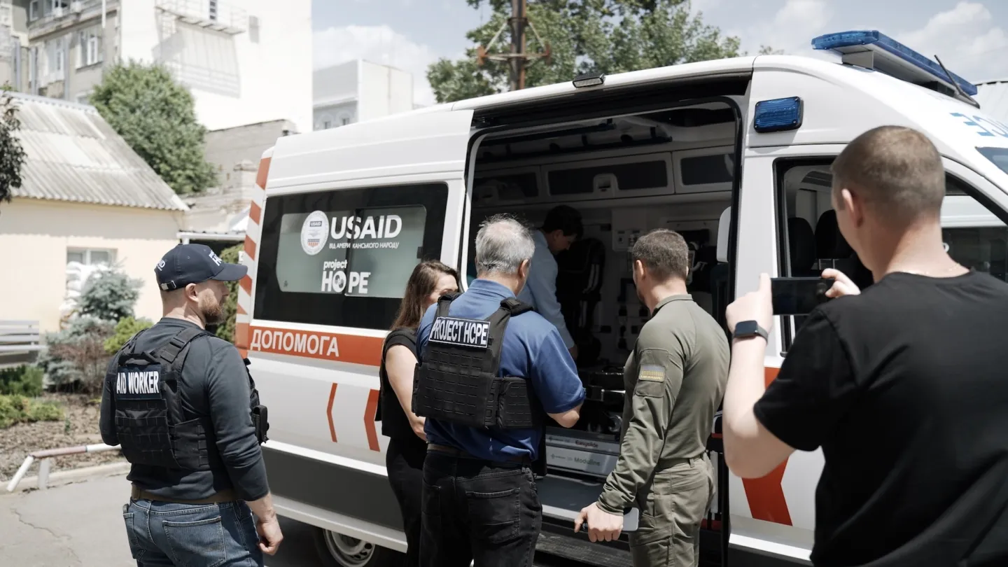 Group of people outside of ambulance