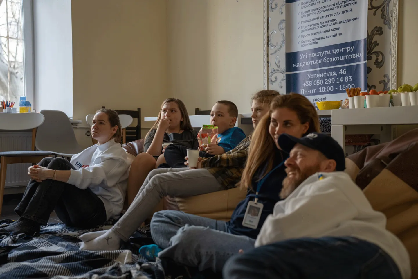 a group of adults and children watching Moana.