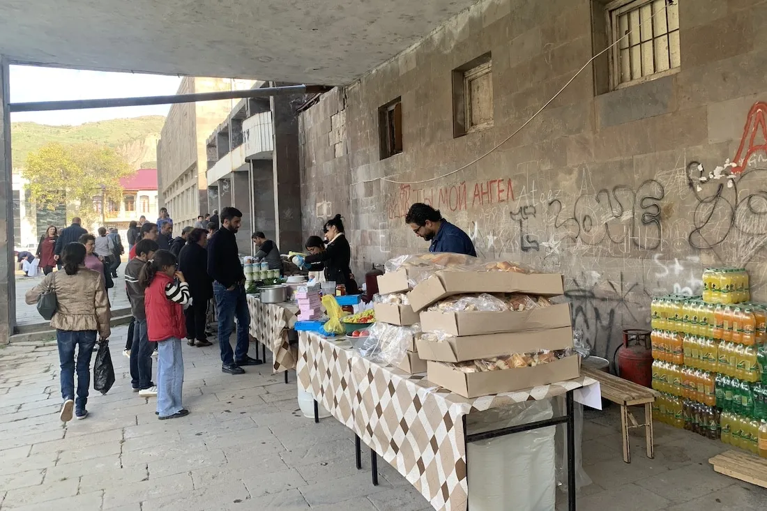 Man standing at table outside building
