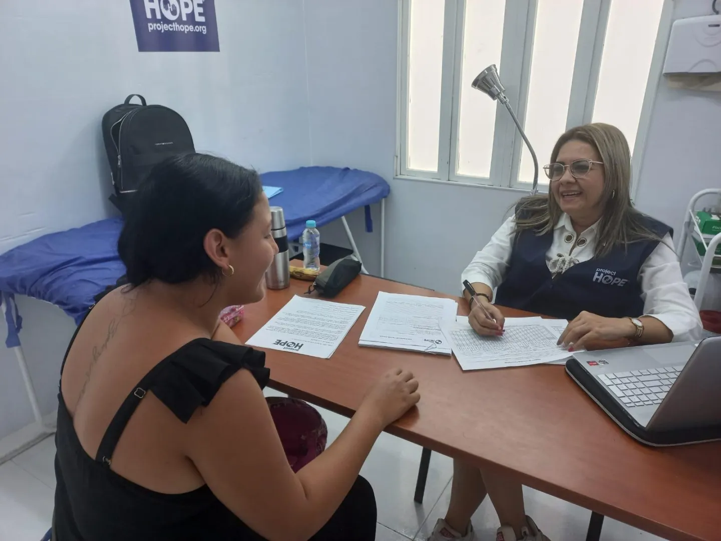 Two women speaking about mental health support in Colombia.