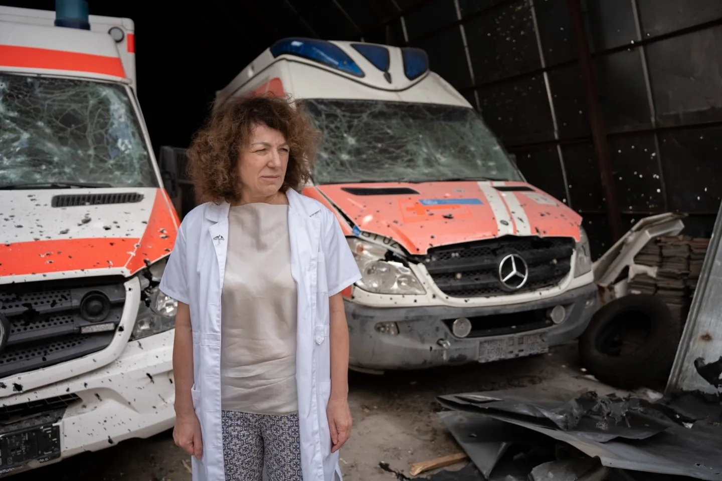 woman standing in front of ambulances