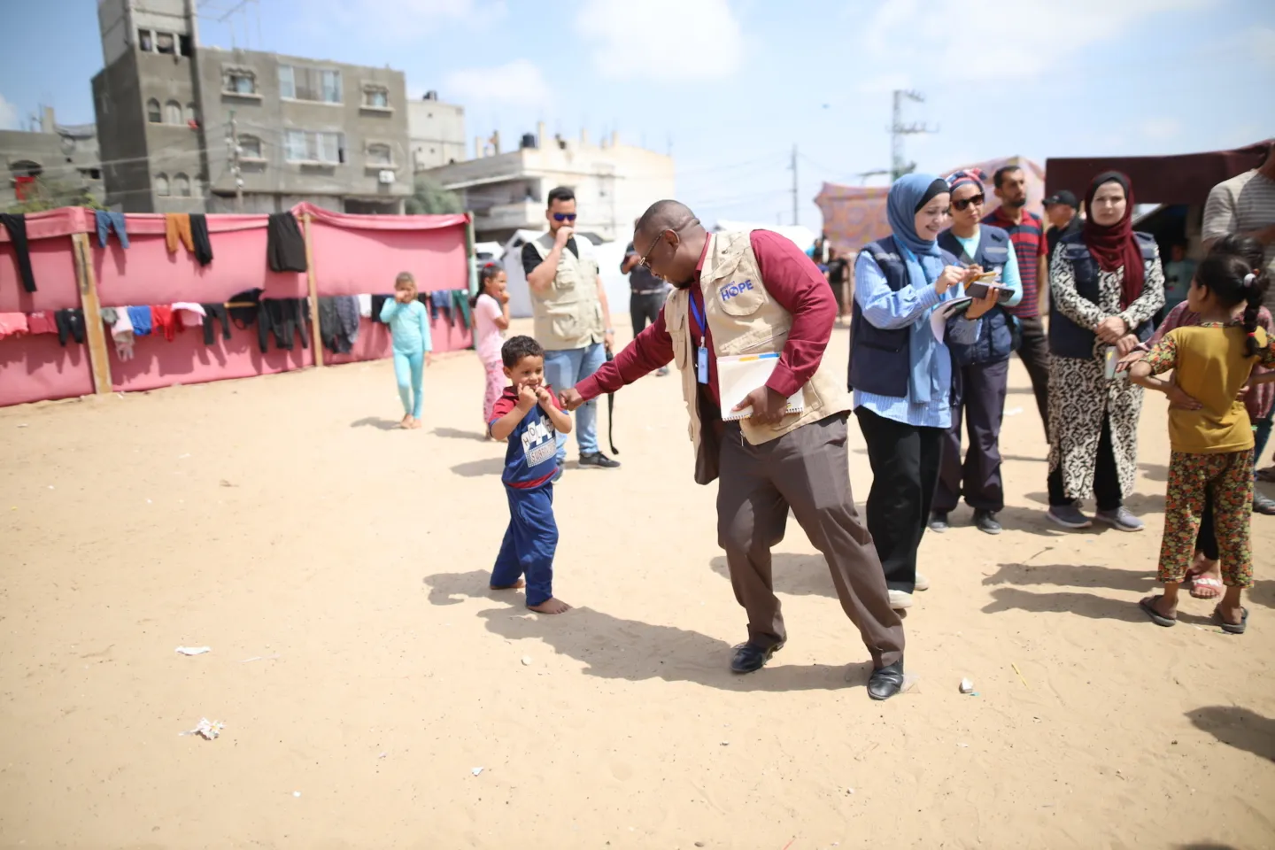 Humanitarian Aid workers walk inside Gaza settlements
