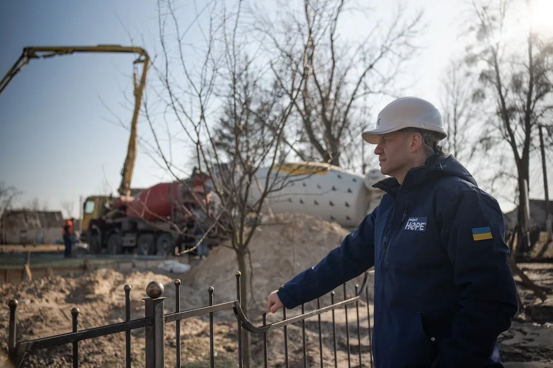 man standing next to construction site
