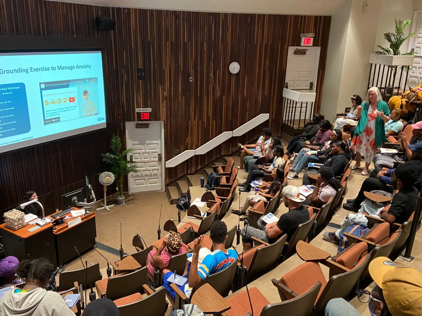 lecture hall full of students learning about mental health