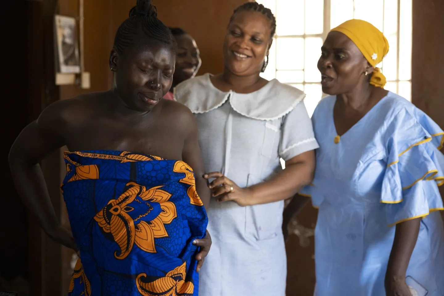 pregnant woman being cared for by midwives in Sierra Leone