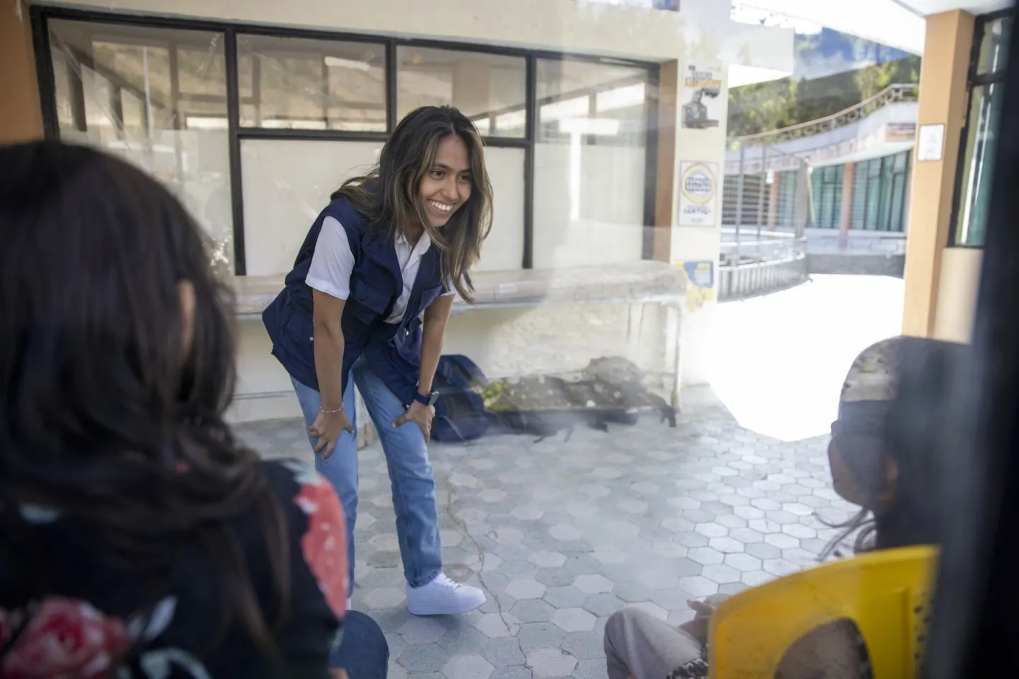 Female psychologist meets with children in Ecuador.