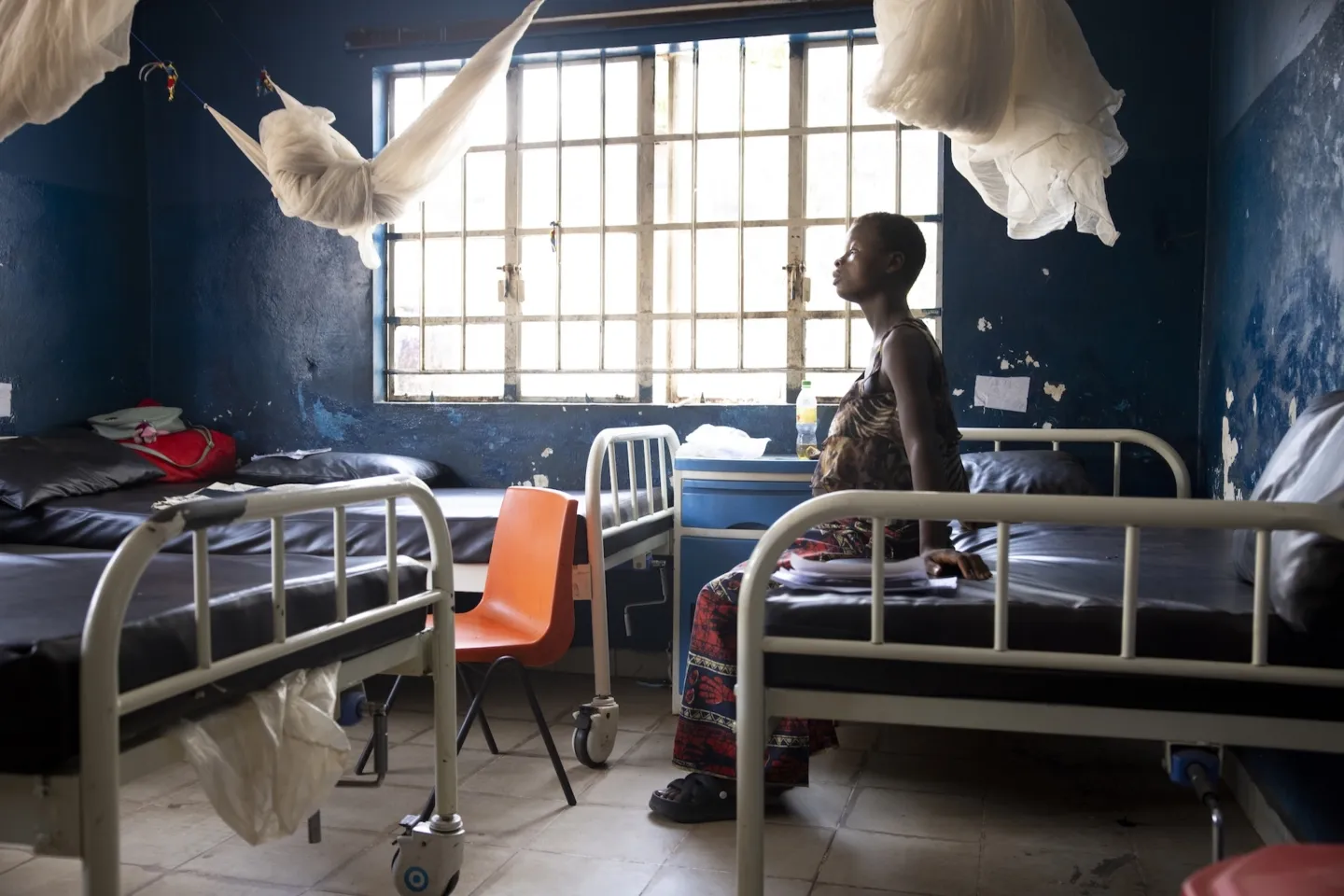 pregnant woman sitting on hospital bed in Sierra Leone going through contractions