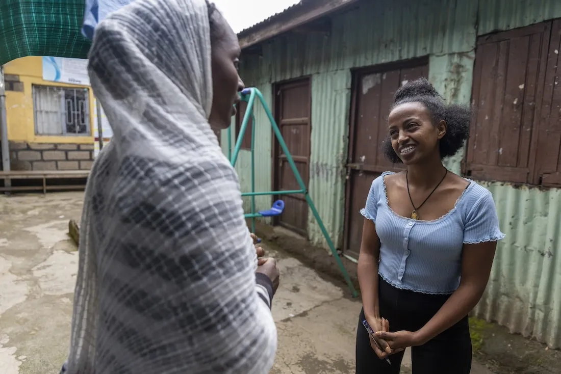 Two women talking outside a house in Ethiopia