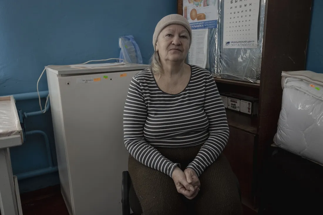 woman with headscarf sits in doctor's office