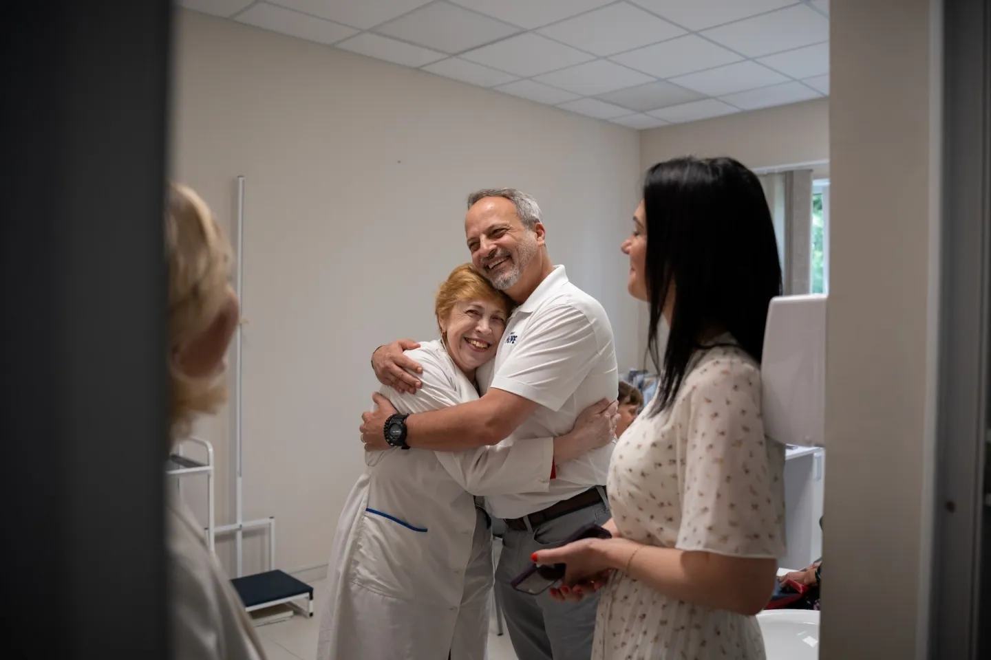 Man and woman hug together inside hospital
