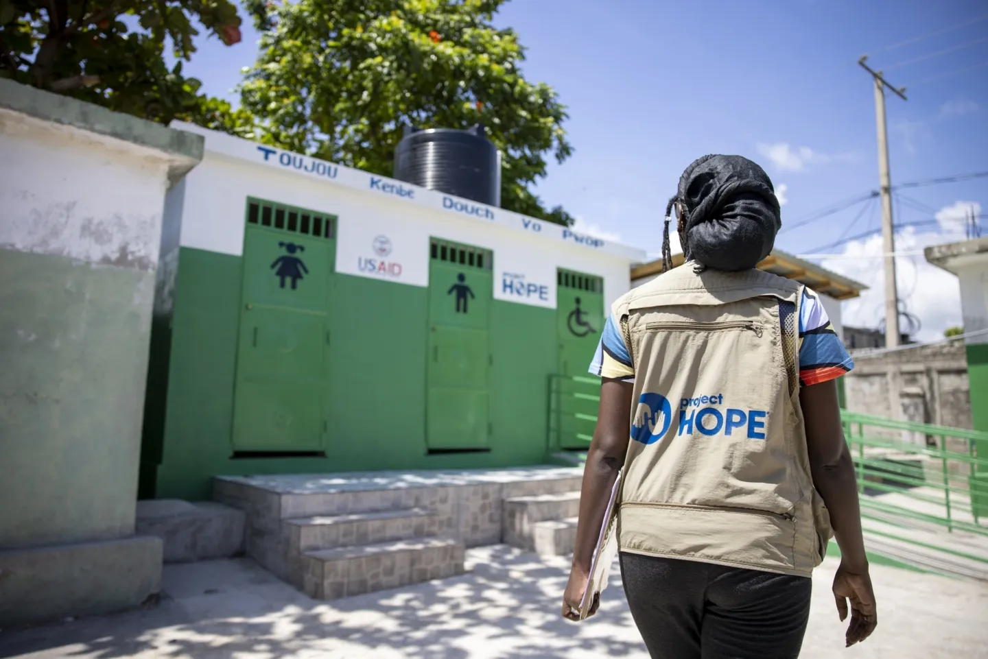Back of Project HOPE staffer walking through Haiti