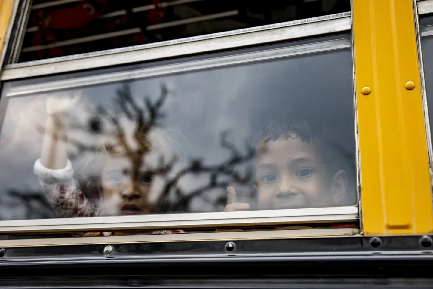 two young children inside of a school bus