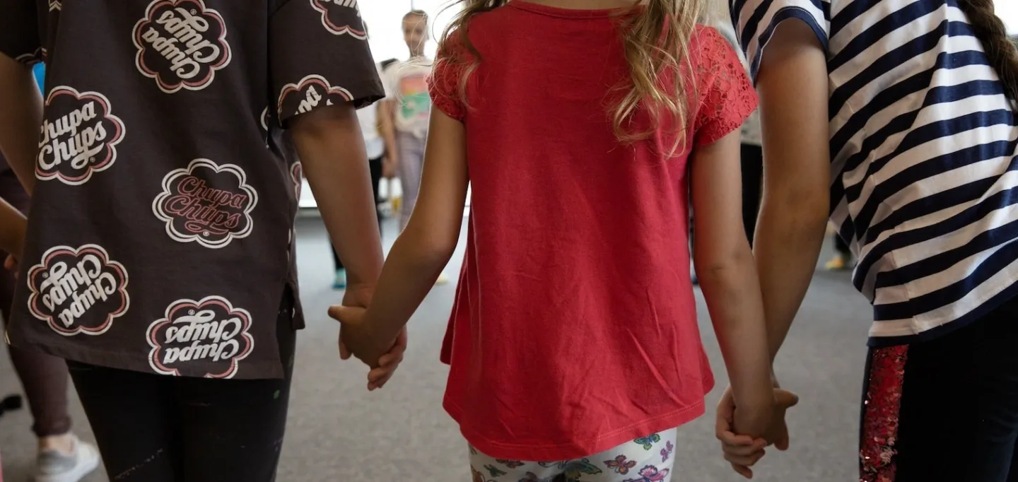 children holding hands in a circle