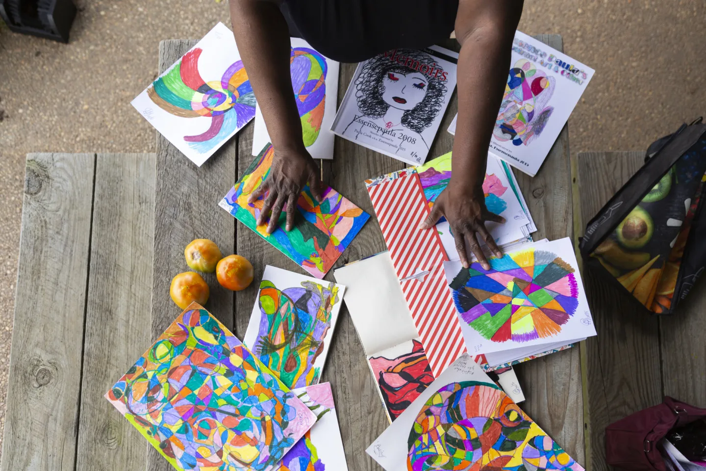 woman showing off colorful art pieces