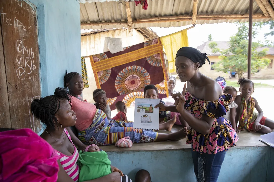 multiple women sitting outside learning about neonatal care