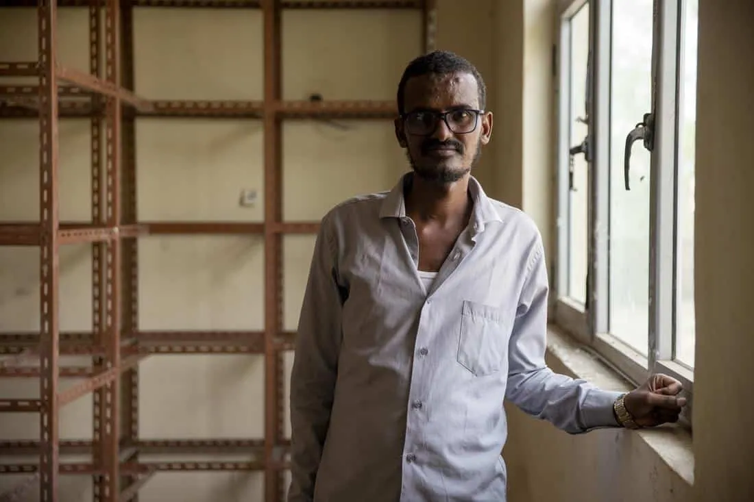 man standing in pharmacy