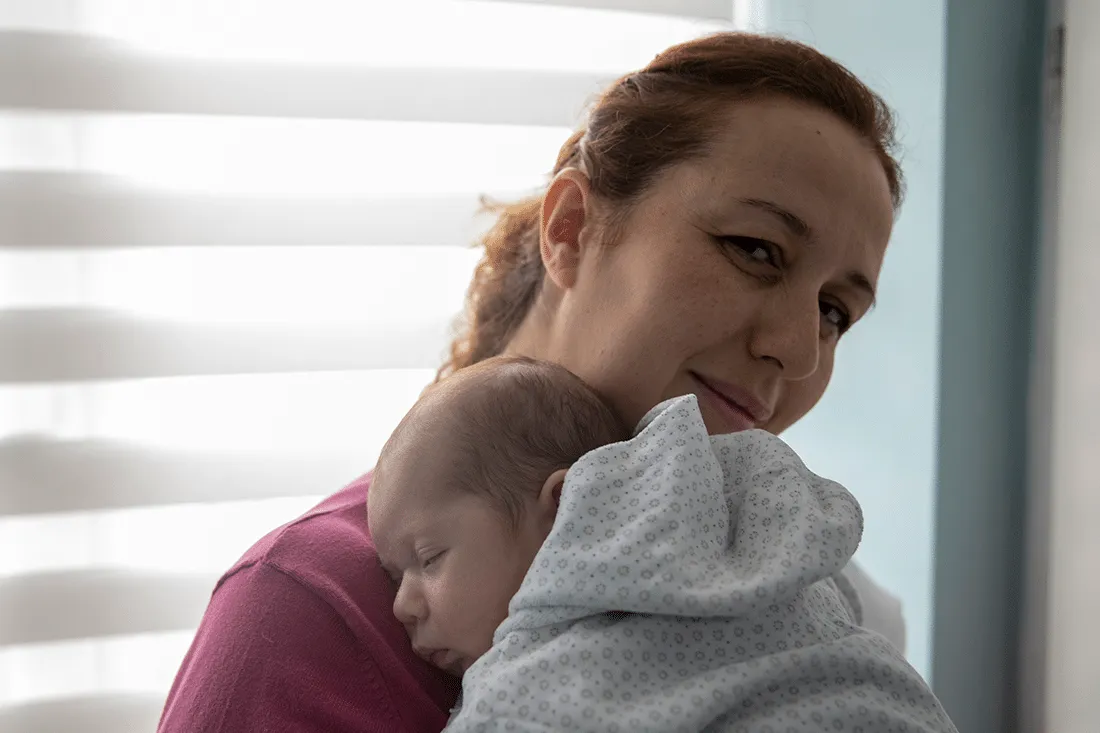 Mother holding her new baby.