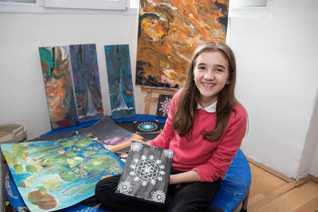 Yllka with the art she sells to afford treatment