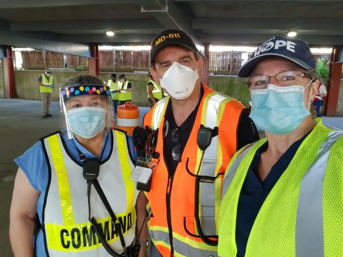 Three medical staff at a COVID-19 vaccination center
