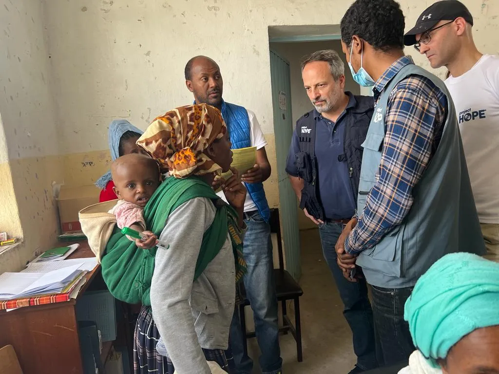 seven people speaking in a room