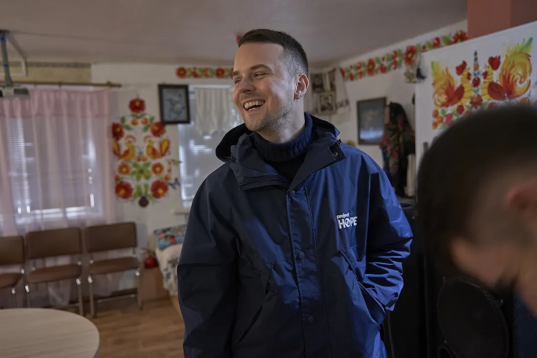 man smiling at something off camera