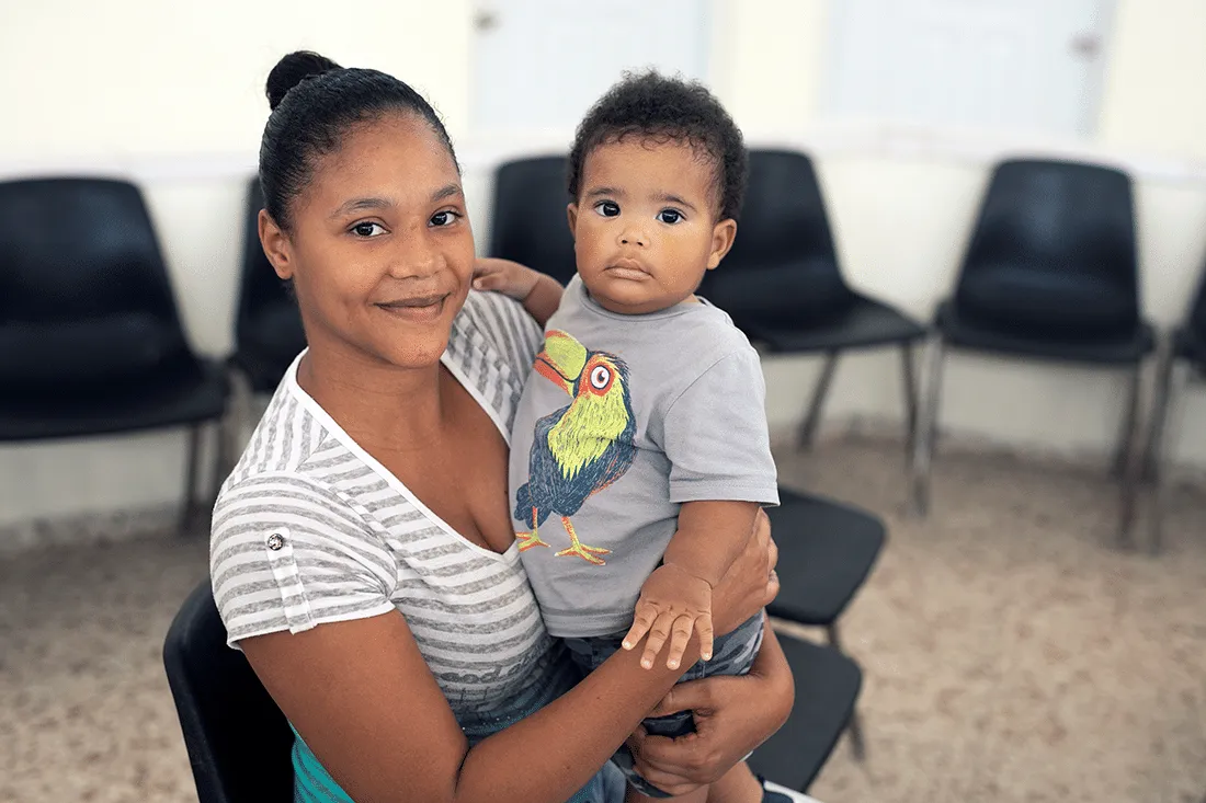 mother holds young son
