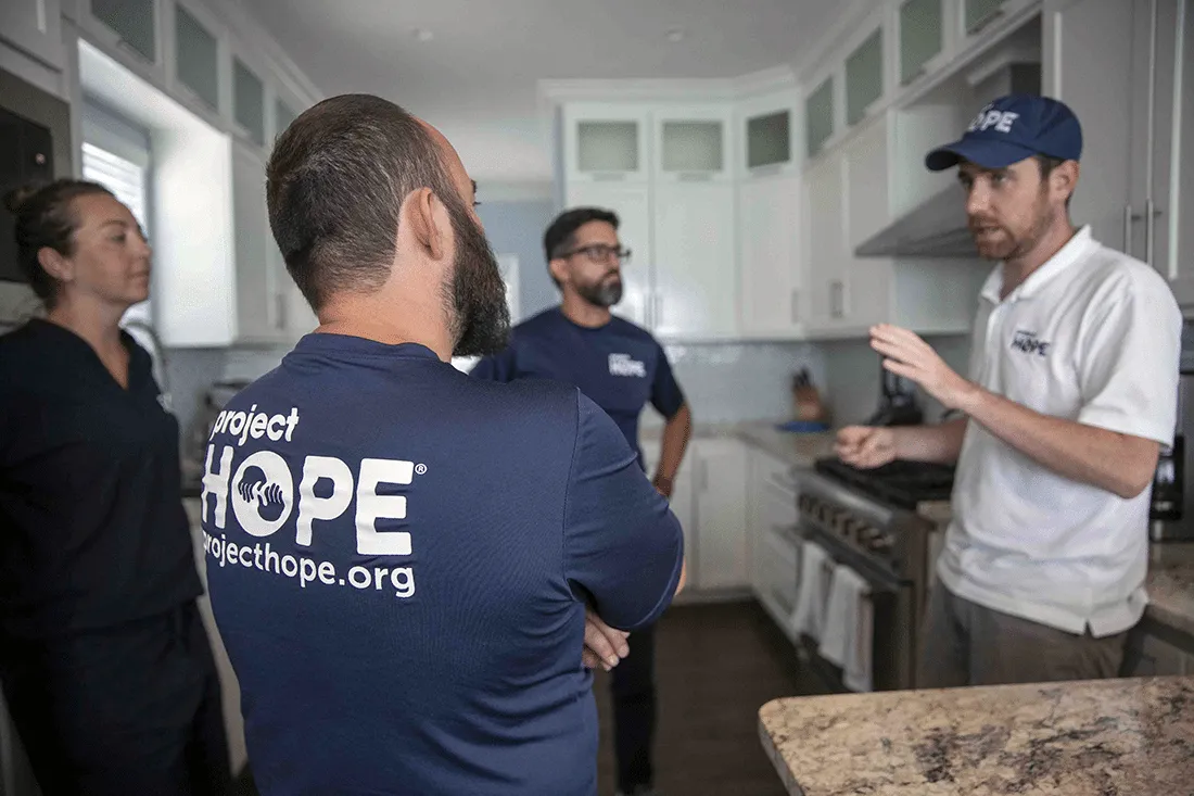 Tom Cotter talking with his team.