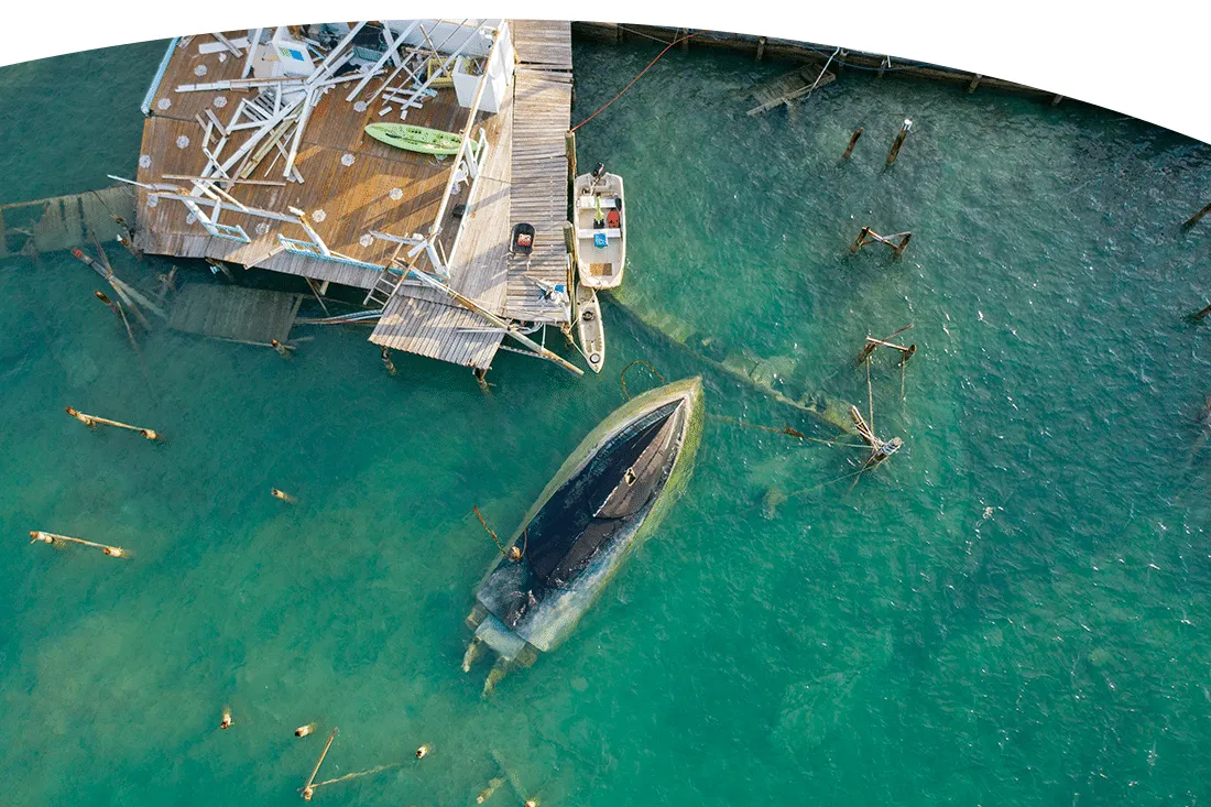 eagle eye view of overturned boat in a destroyed harbor