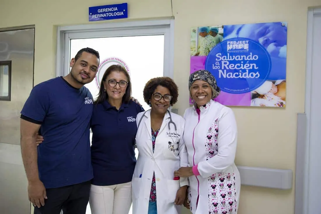 Staff and nurses posing together and smiling at the camera