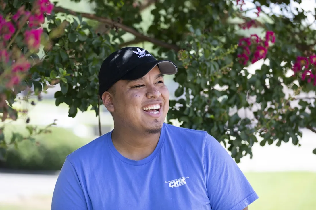man standing in front of flowers