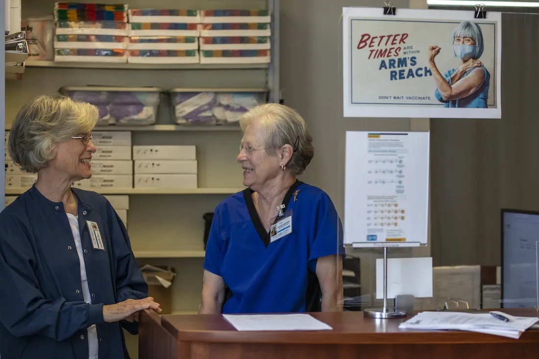 Two medical staff talking inside a clinic in the US