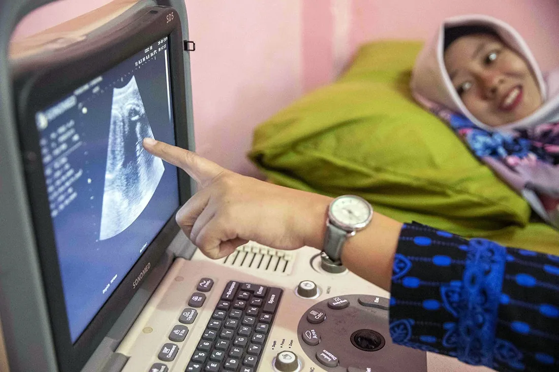 Midwife showing sonogram for pregnant woman