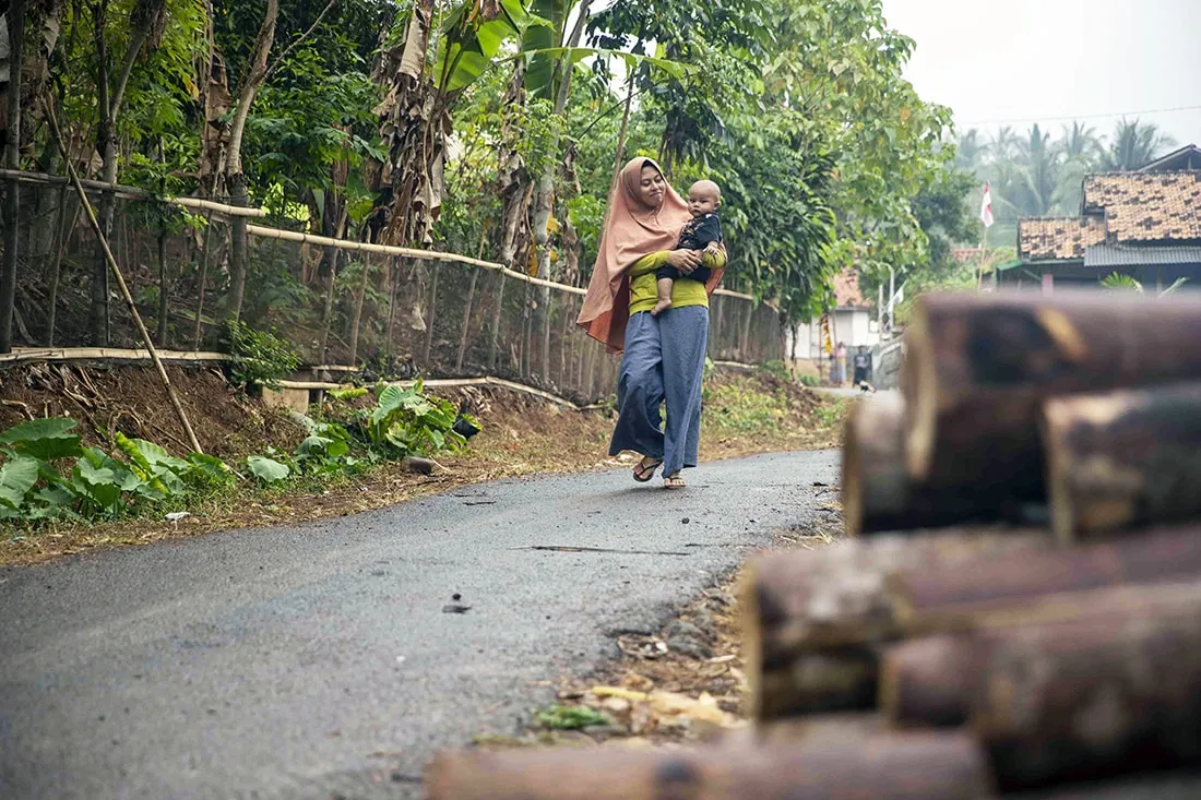 Mother carrying newborn child