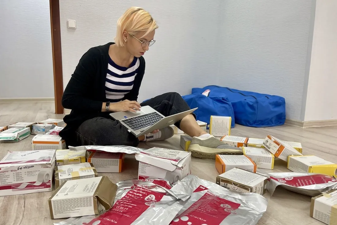 Kateryna sorts through large piles of donations