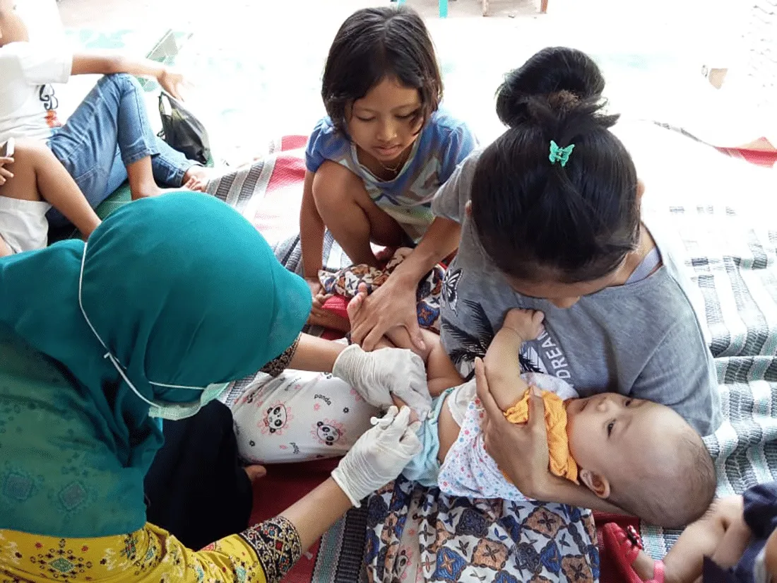 nurse with mother and two children