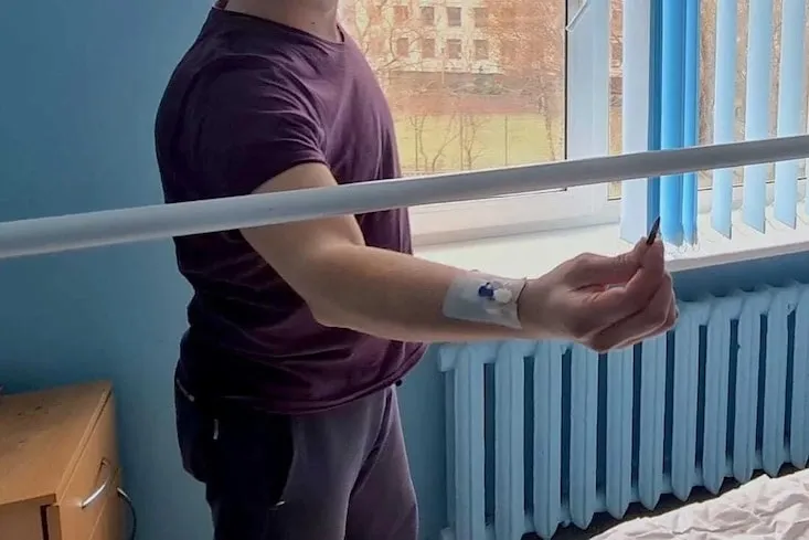 a patient holding a bullet that was removed from body