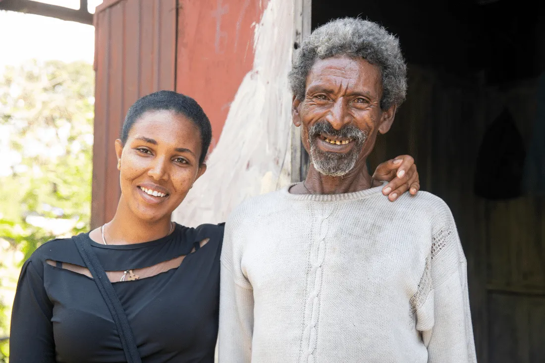 Adunga smiles next to the healthcare worker who saved his life.