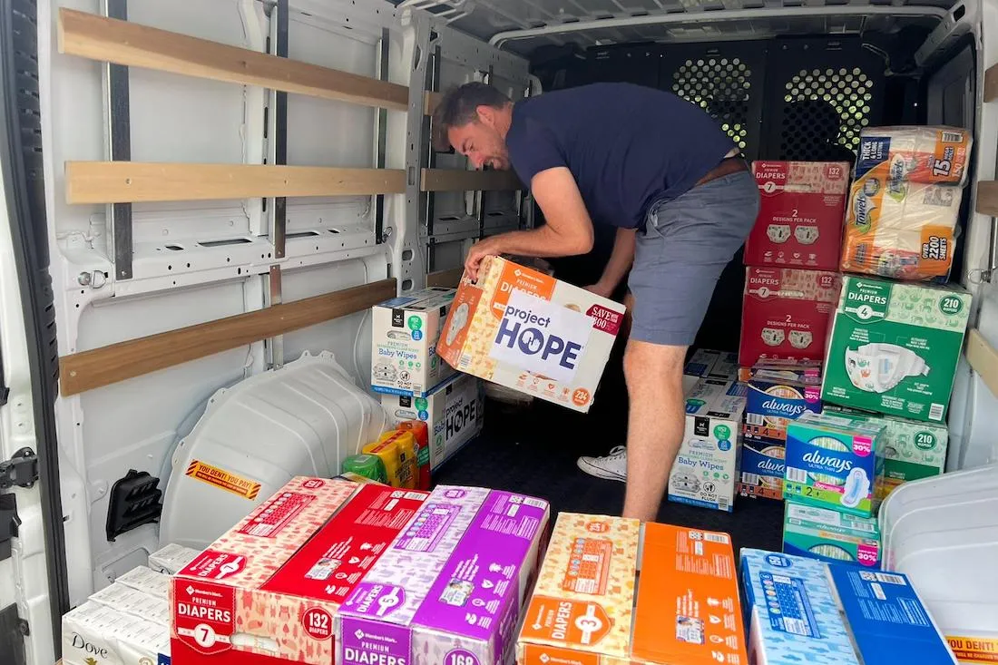 man loading boxes in van