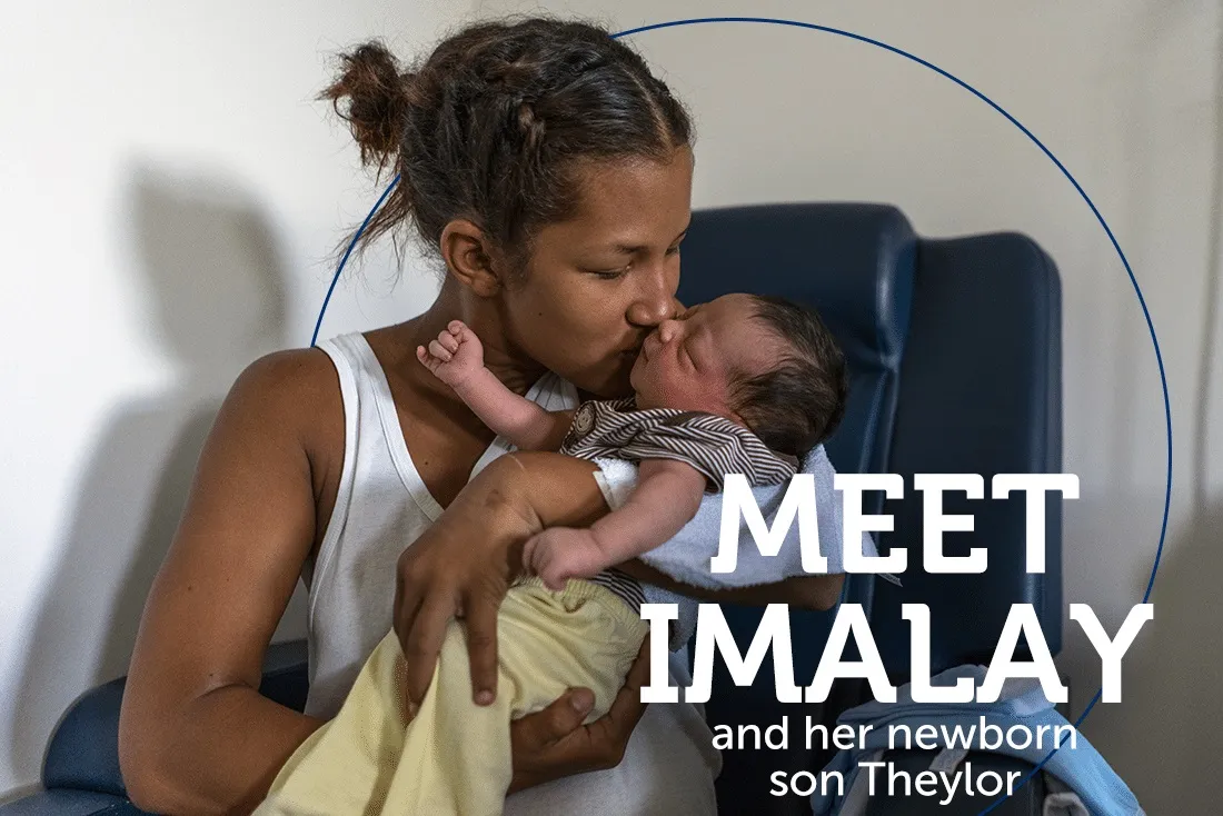 Mother kisses newborn baby